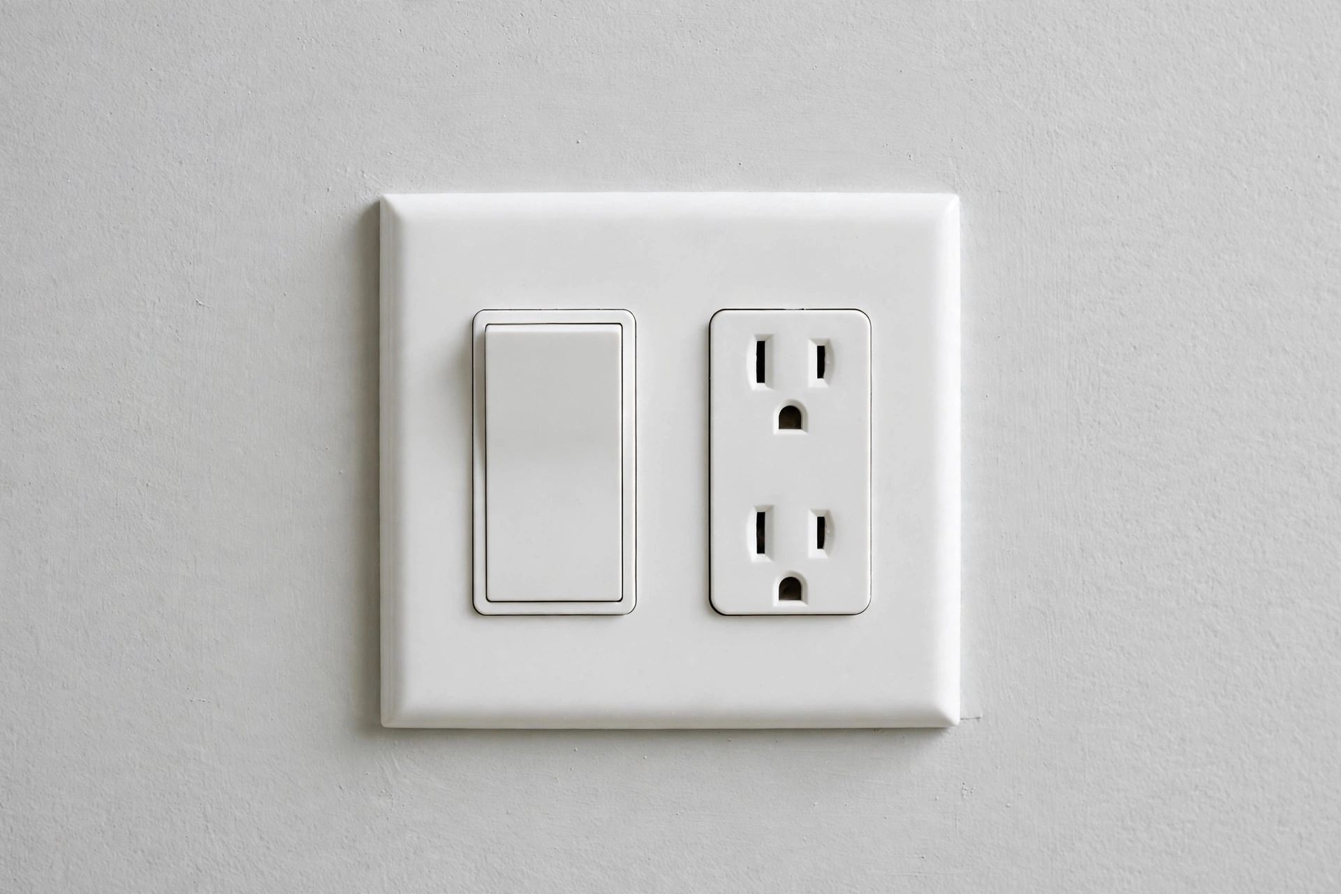 Cleanly installed white outlet and wall switch